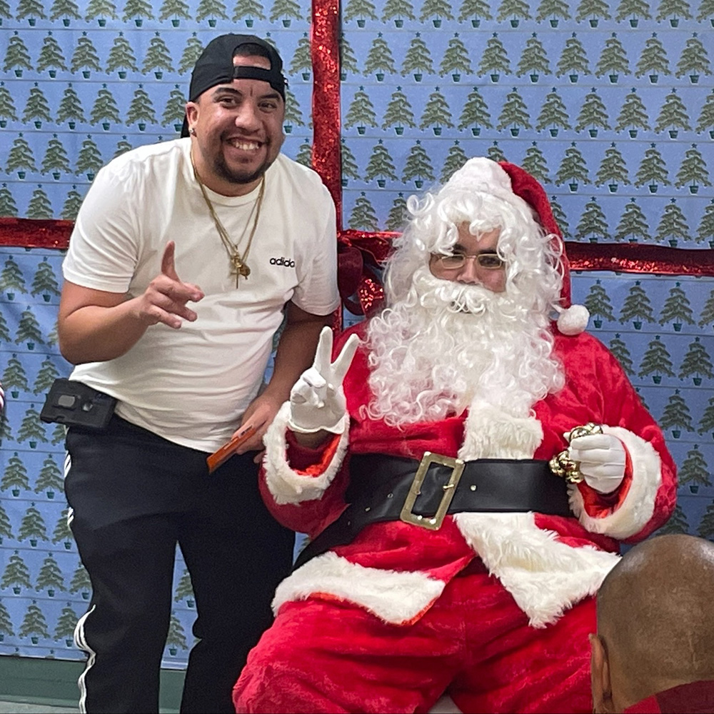 program participant throwing a peace sign with Santa